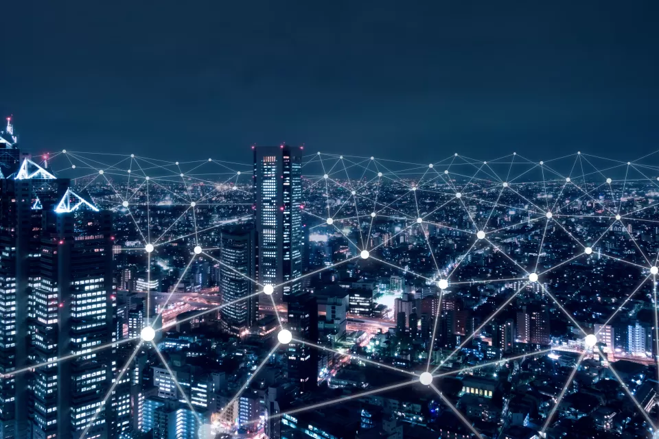 Illustration of nighttime city with white lines connecting nodes to illustrate technology and connectivity